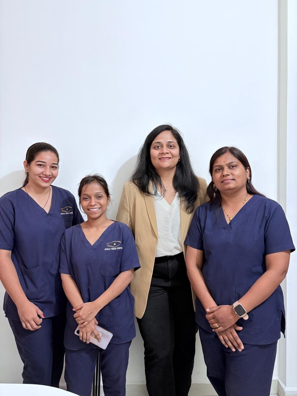 Dental clinic team in Indore standing together in professional uniforms.